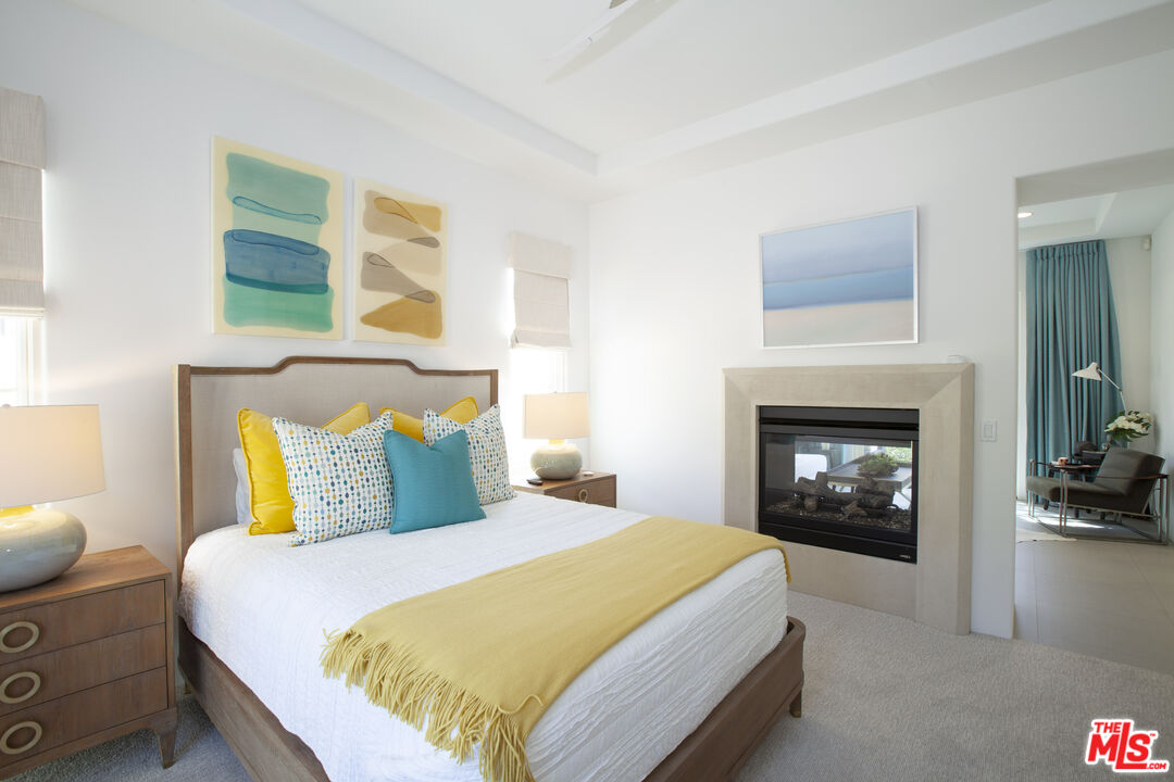 81805 Andalusia La Quinta, CA 92253 - Photo 33 of 45 a bedroom with a bed and a fireplace