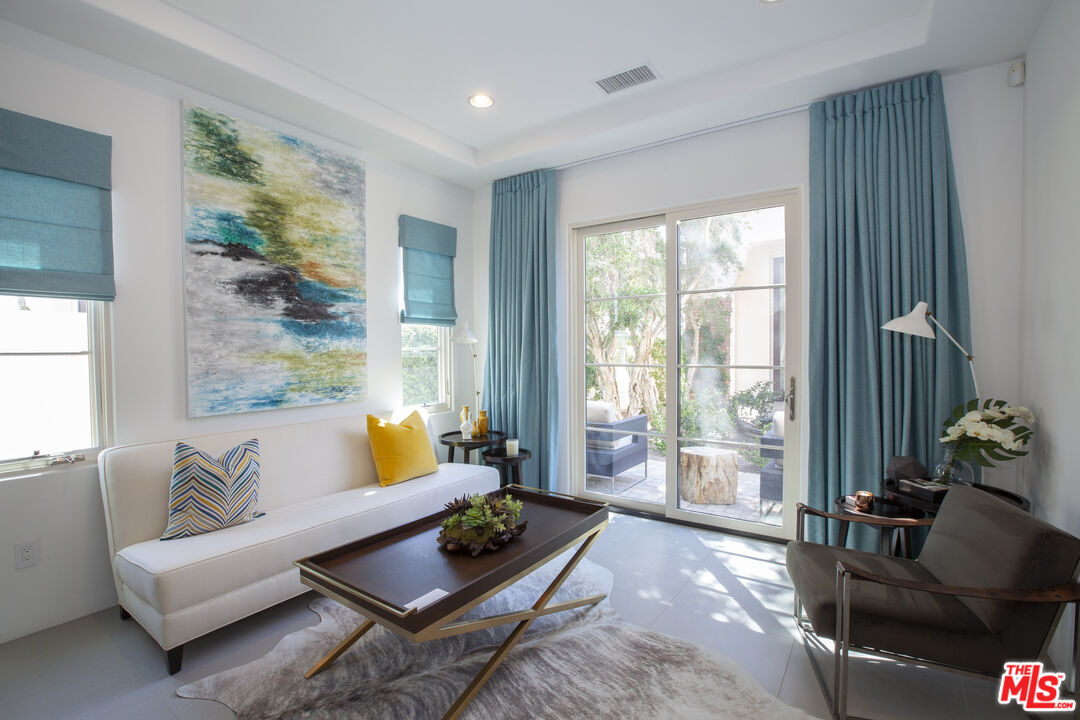 81805 Andalusia La Quinta, CA 92253 - Photo 35 of 45 a living room with furniture and a potted plant