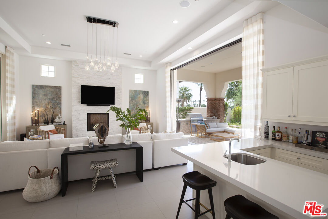 81805 Andalusia La Quinta, CA 92253 - Photo 39 of 45 a living room with furniture a flat screen tv and a large window