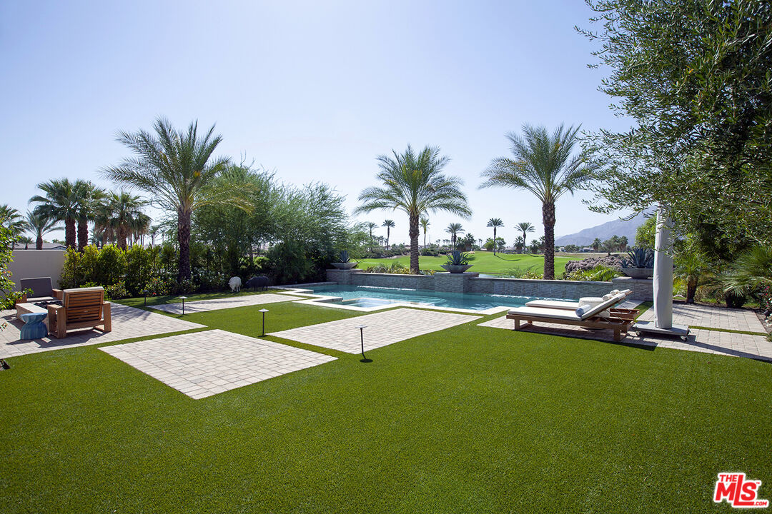 81805 Andalusia La Quinta, CA 92253 - Photo 41 of 45 a view of a swimming pool with a table and chairs