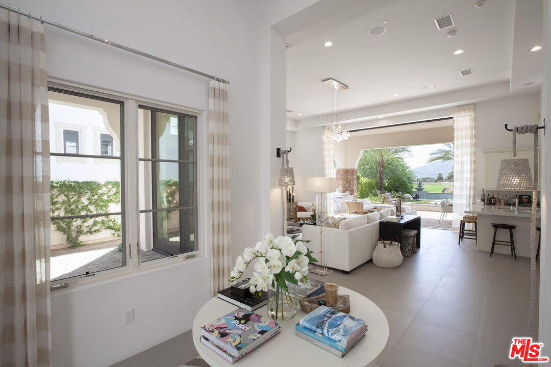 81805 Andalusia La Quinta, CA 92253 - Photo 6 of 45 a living room with furniture and floor to ceiling windows