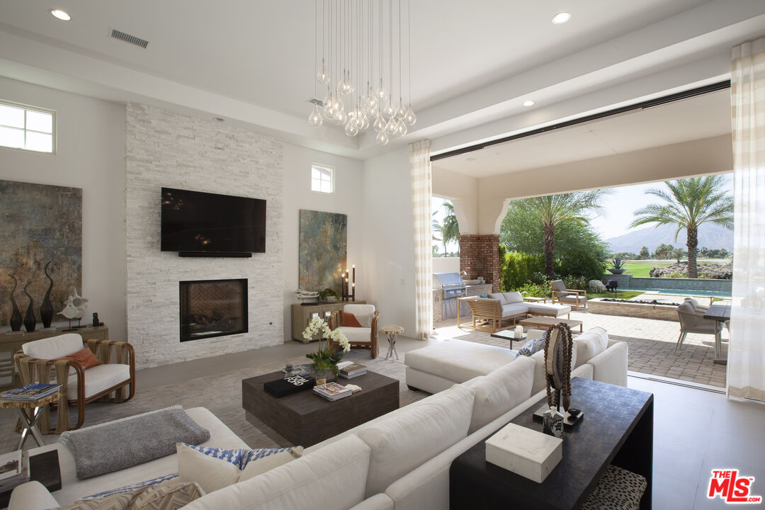 81805 Andalusia La Quinta, CA 92253 - Photo 9 of 45 a living room with fireplace furniture and a flat screen tv
