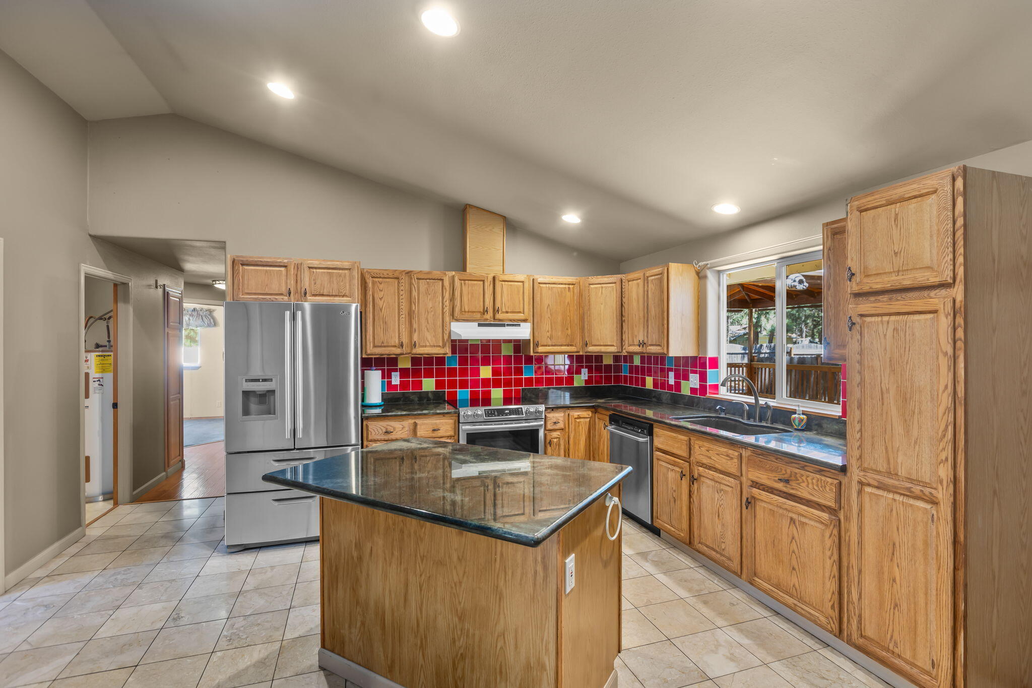 59842 Navajo Road Bend, OR 97702 - Photo 7 of 52 a kitchen that has a lot of cabinets a sink and a refrigerator
