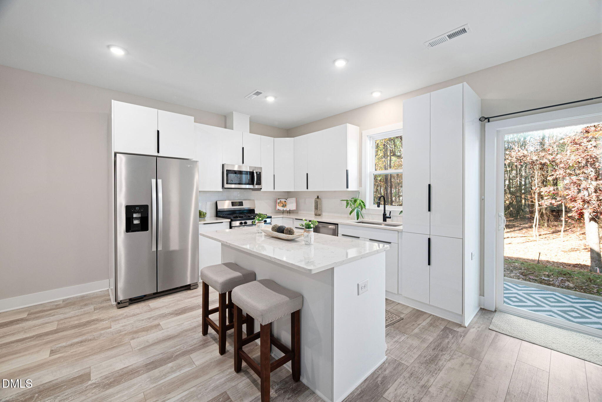 4208 Convergence Street Durham, NC 27704 - Photo 11 of 38 a kitchen with refrigerator cabinets and wooden floor