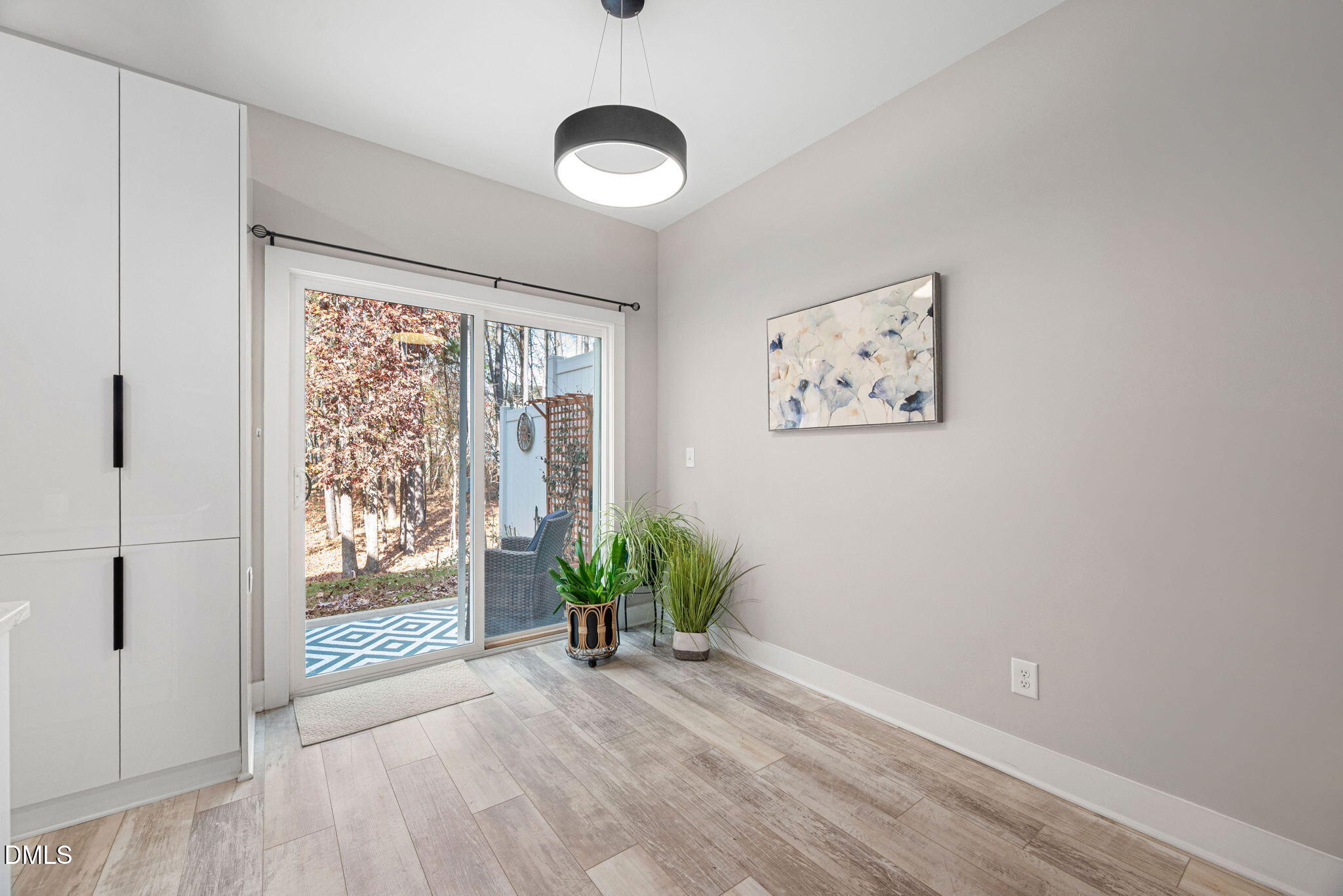 4208 Convergence Street Durham, NC 27704 - Photo 14 of 38 a view of an empty room with a window and wooden floor