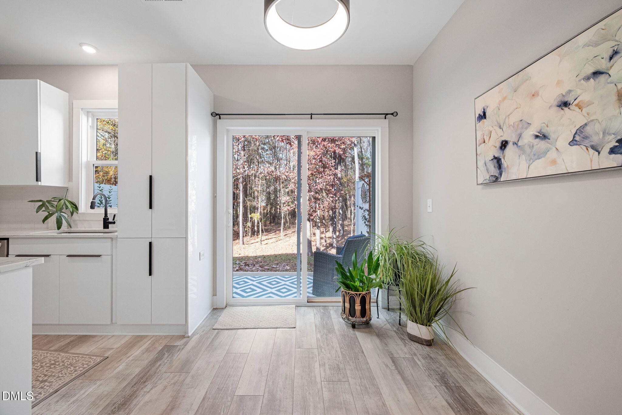 4208 Convergence Street Durham, NC 27704 - Photo 16 of 38 a hallway with view of wooden floor and a potted plant