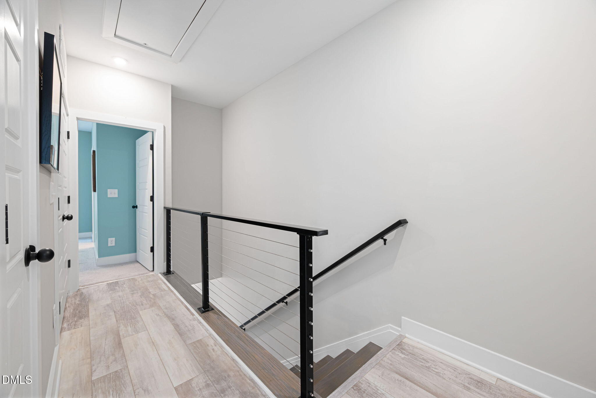4208 Convergence Street Durham, NC 27704 - Photo 18 of 38 a view of a hallway with wooden floor and staircase