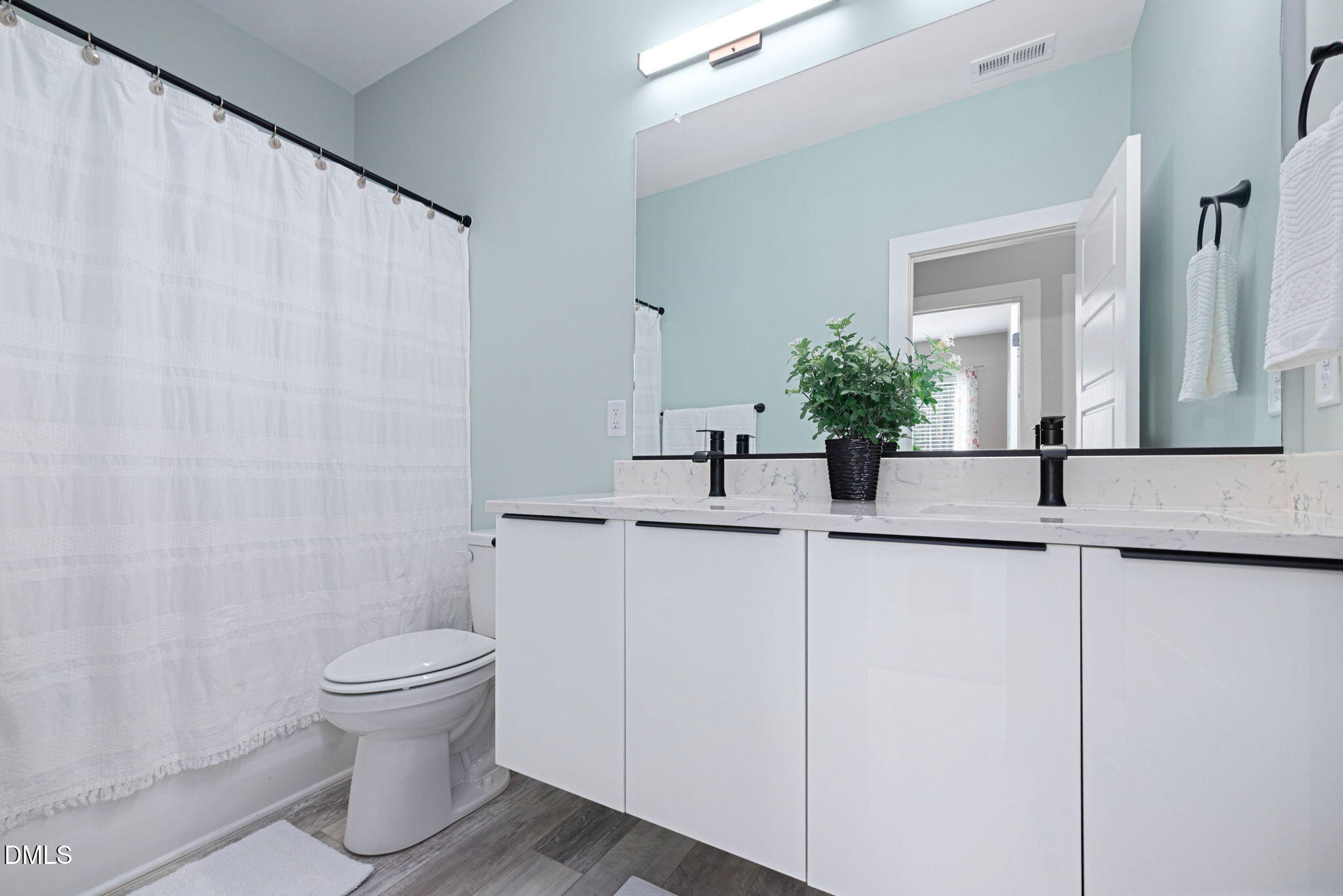 4208 Convergence Street Durham, NC 27704 - Photo 23 of 38 a bathroom with a sink a toilet and mirror