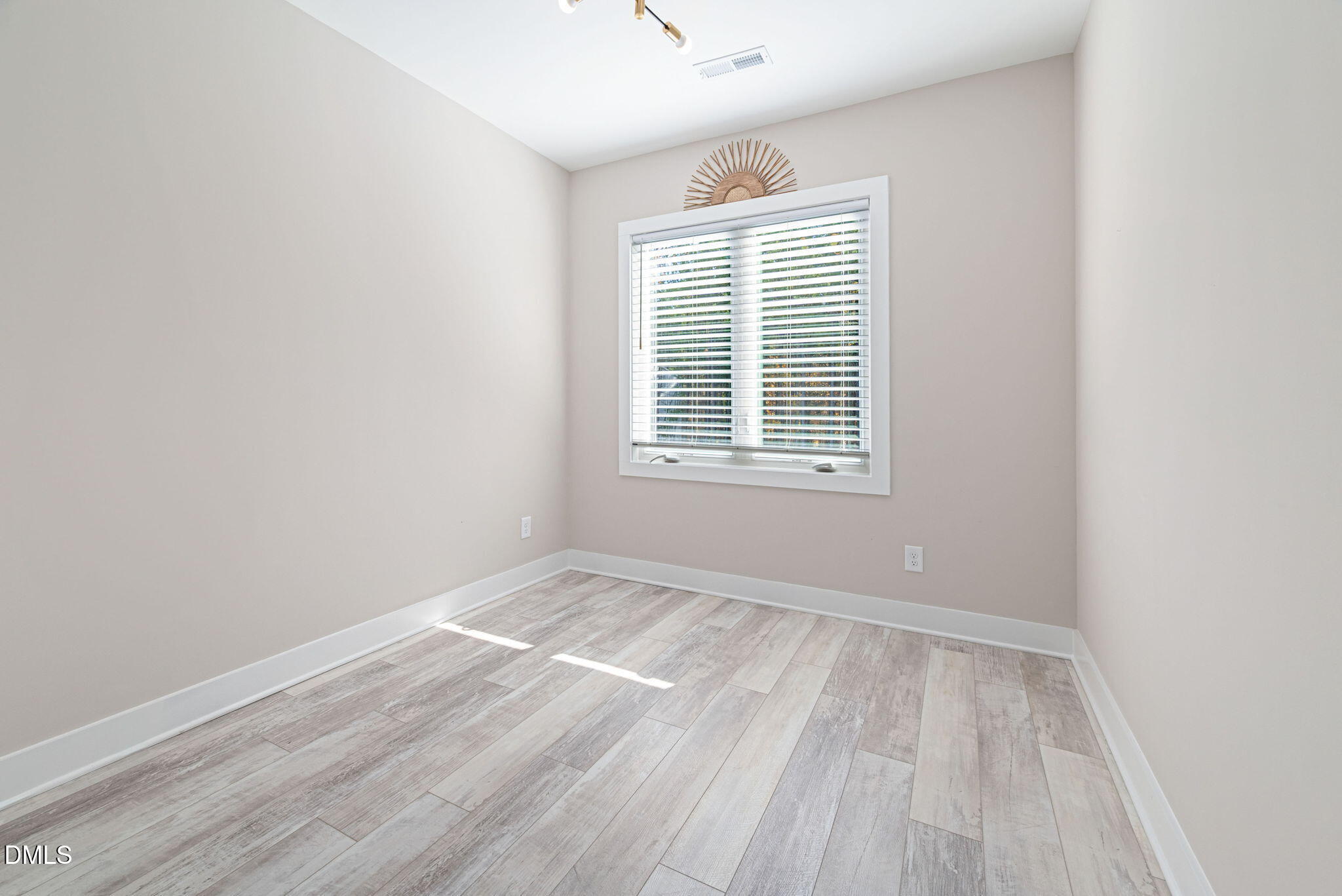 4208 Convergence Street Durham, NC 27704 - Photo 24 of 38 a view of an empty room with wooden floor and a window