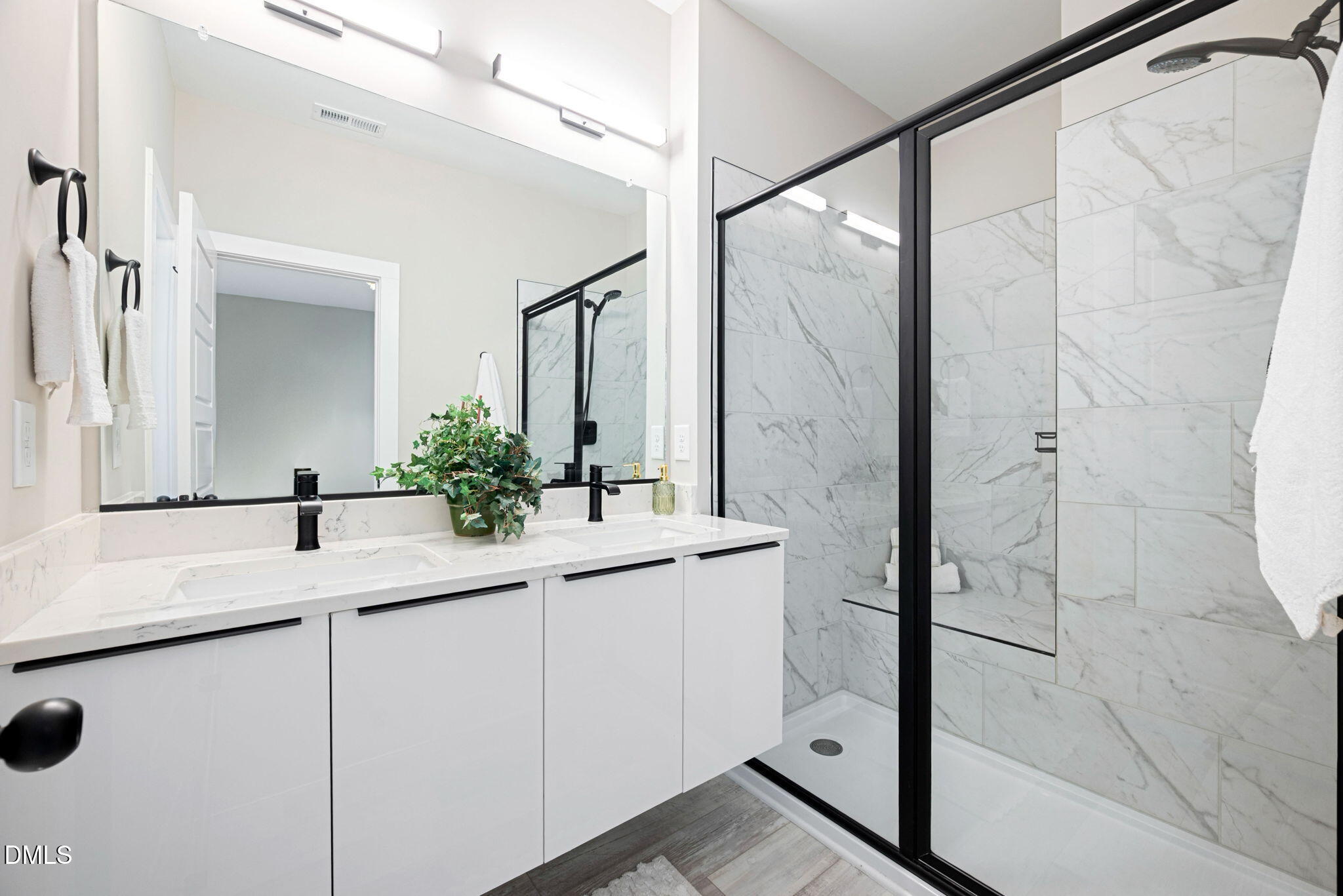 4208 Convergence Street Durham, NC 27704 - Photo 29 of 38 a bathroom with a granite countertop sink mirror and a shower