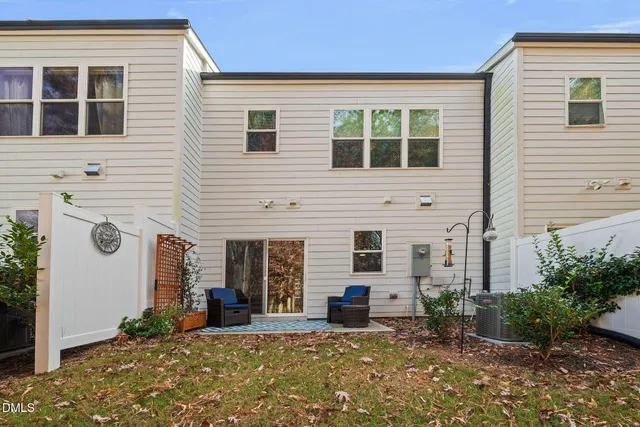 a view of a house with a yard and potted plants