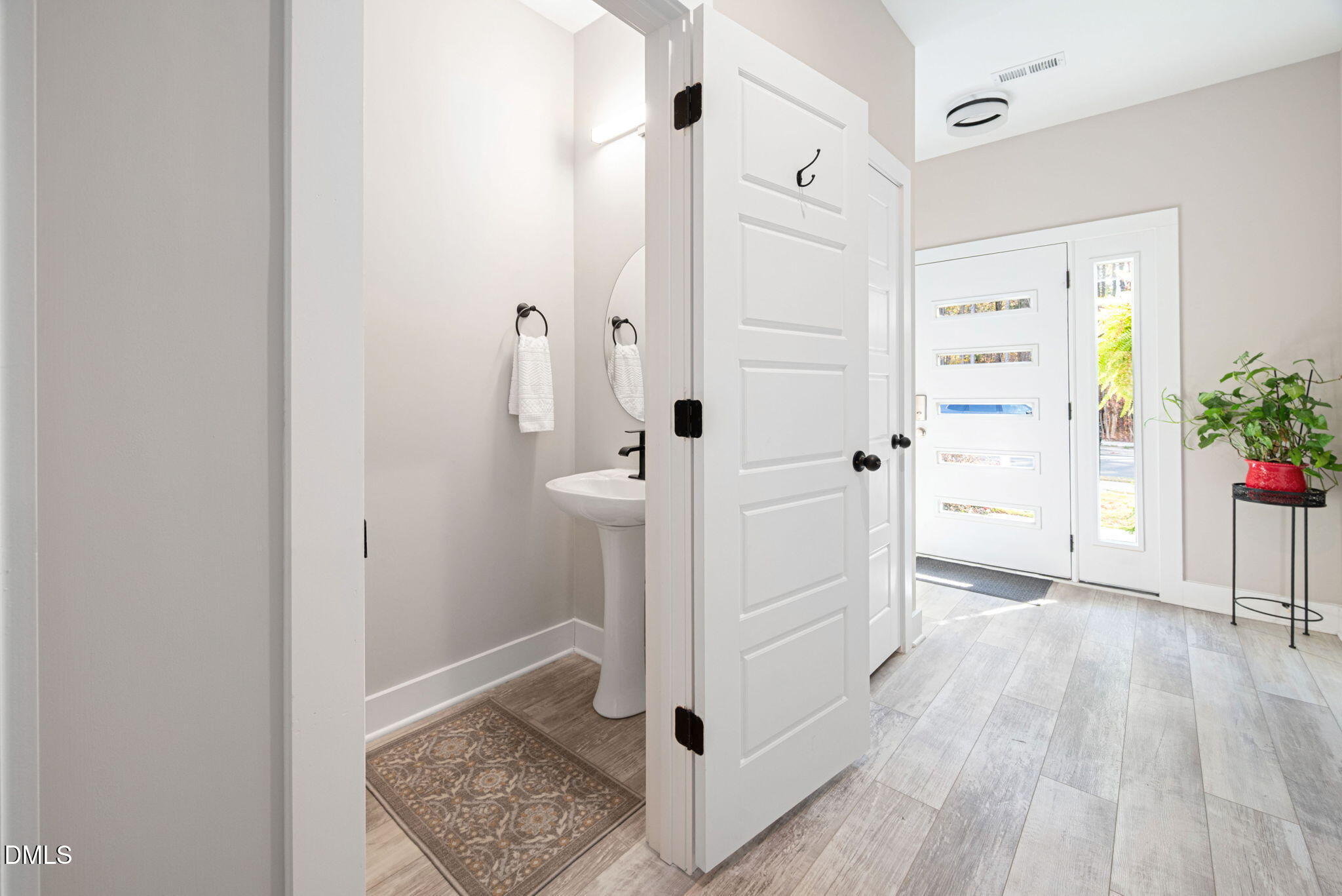 4208 Convergence Street Durham, NC 27704 - Photo 7 of 38 a view of a hallway with wooden floor and staircase