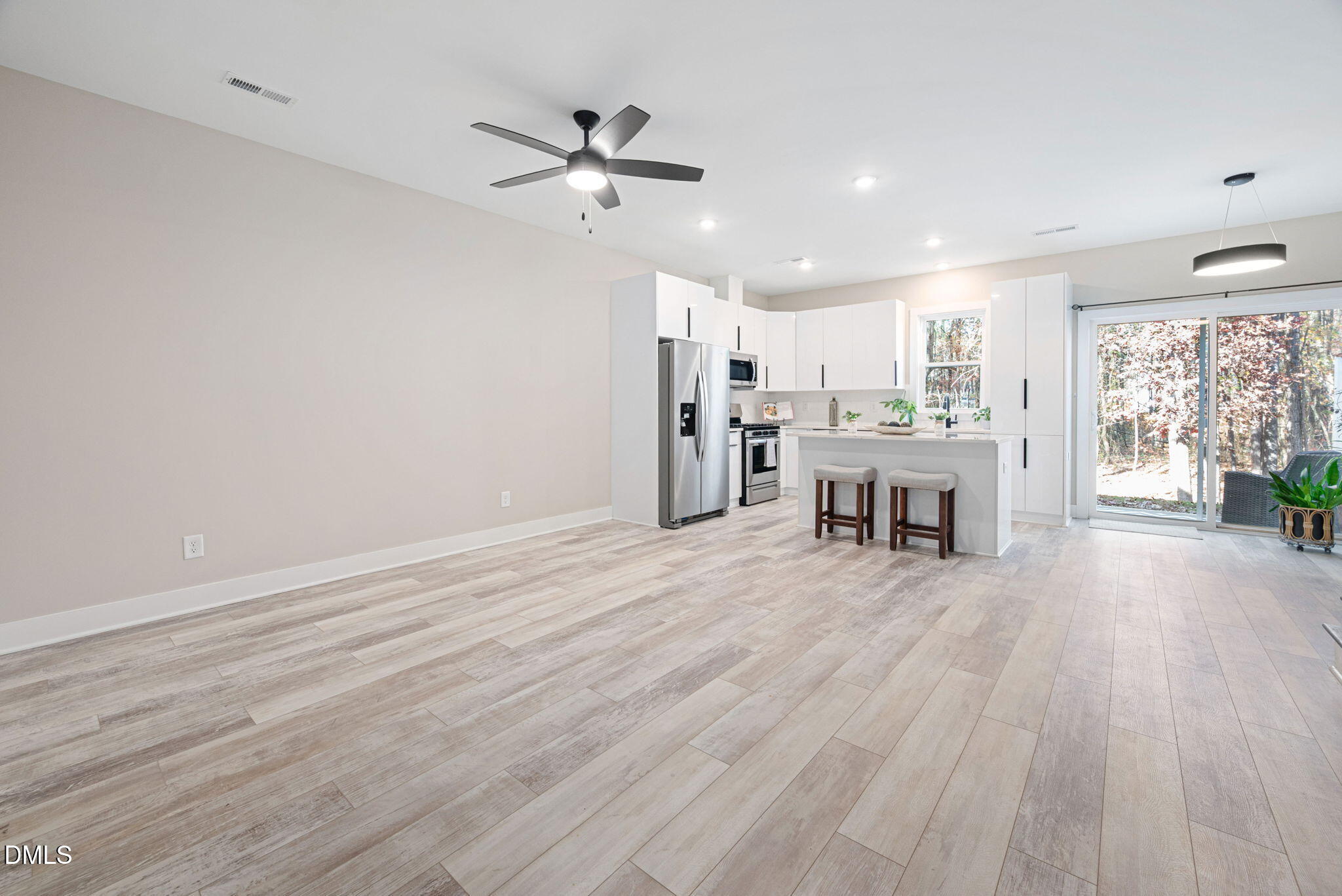 4208 Convergence Street Durham, NC 27704 - Photo 8 of 38 a view of a kitchen with furniture and wooden floor