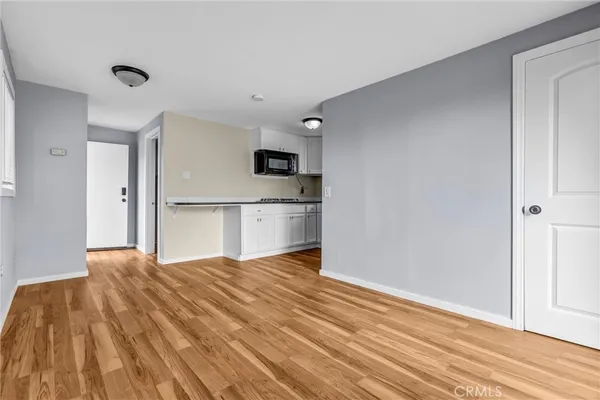 a bedroom with a bed and a view of kitchen