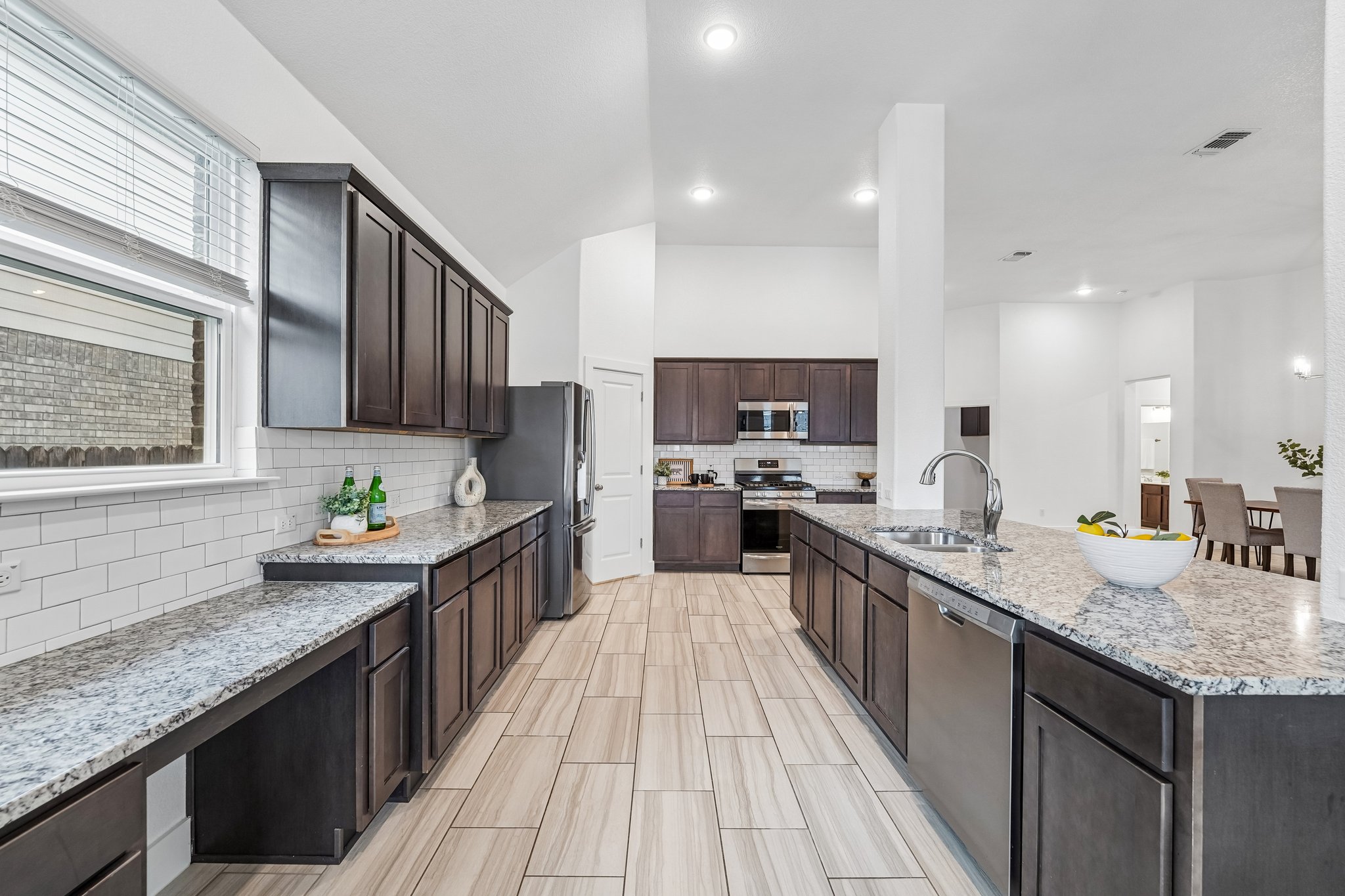 201 Potts Street Georgetown, TX 78628 - Photo 7 of 27 Granite countertops and ample workspace make this kitchen a dream for any serious cook.