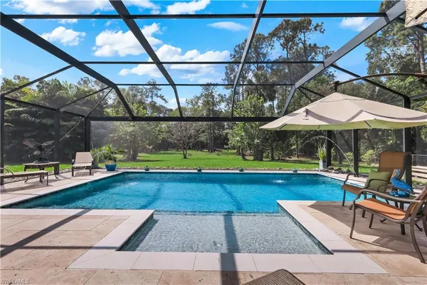 a view of yard with swimming pool and sitting area