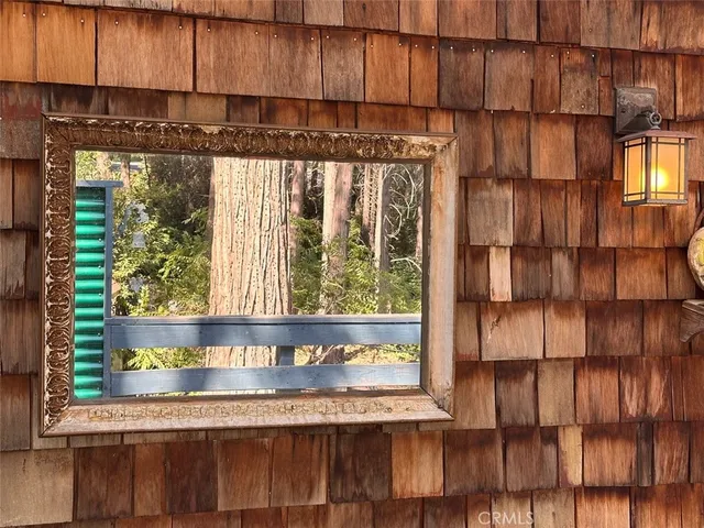 a view of a balcony with chairs and wooden floor