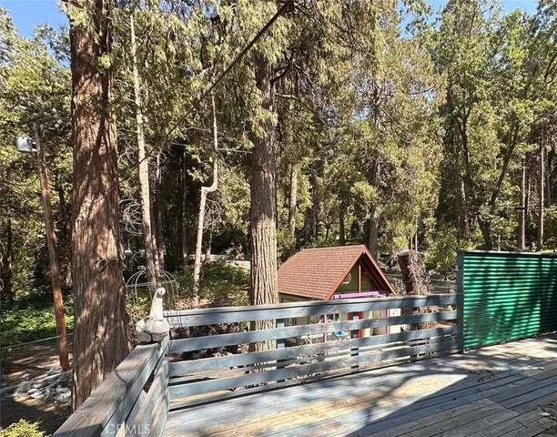 a view of a dry yard with mountains in the background