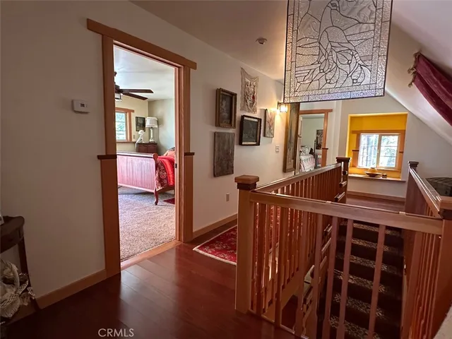 a view of a house with a small yard and potted plants