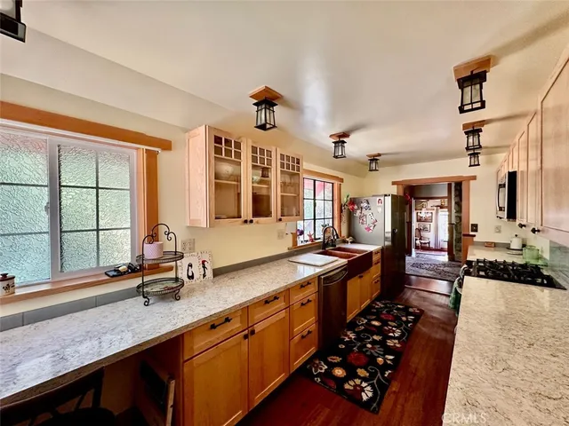 a large kitchen with granite countertop a sink and a stove