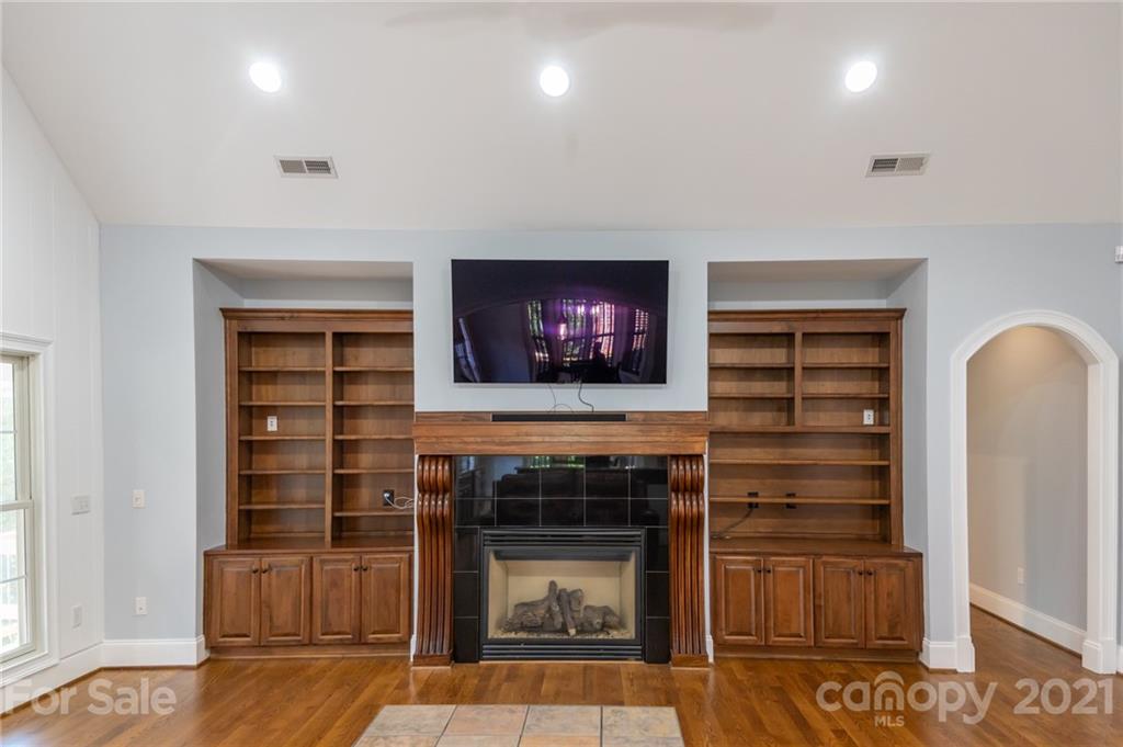 6723 Fox Ridge Circle Davidson, NC 28036 - Photo 10 of 42 a living room with furniture a flat screen tv and a fireplace