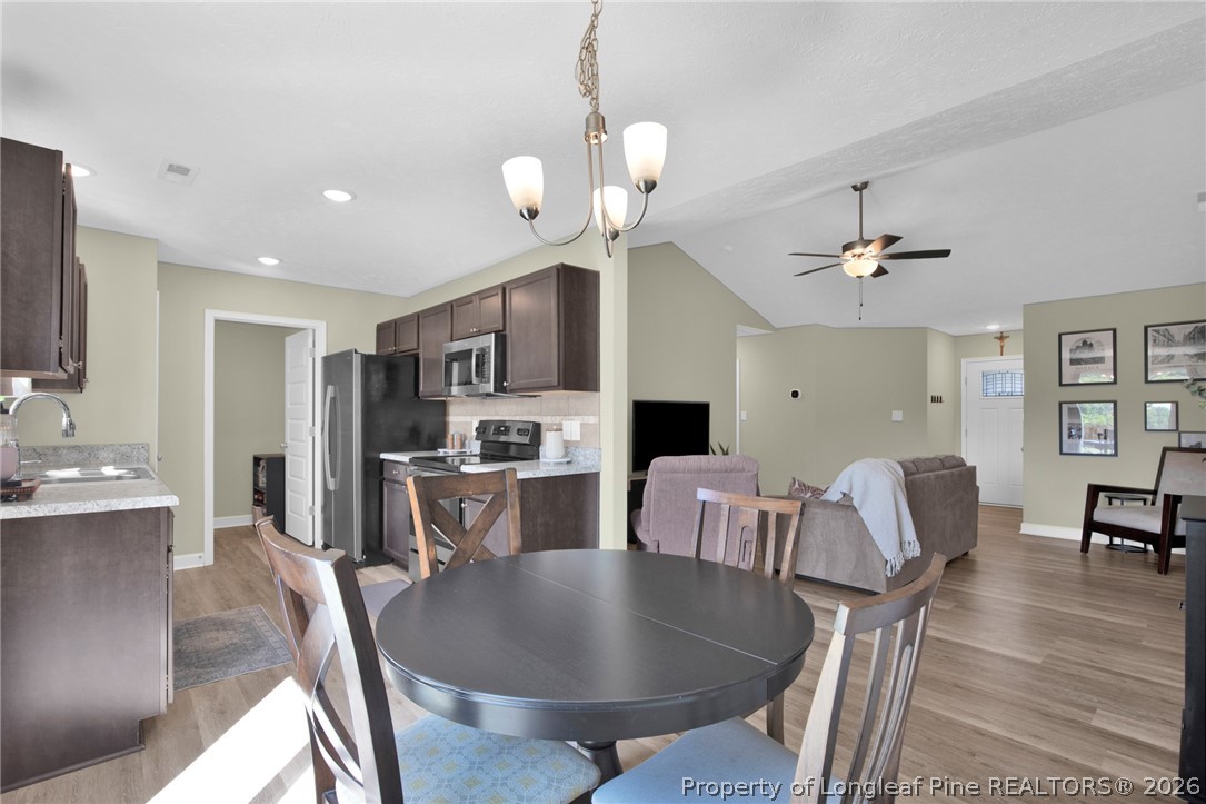 351 Sandy Grove Road Parkton, NC 28371 - Photo 9 of 30 a living room with dining table and chairs