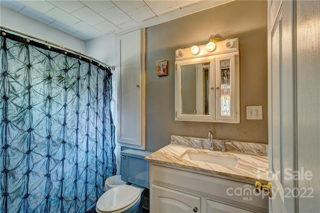 1119 Black Road Cherryville, NC 28021 - Photo 12 of 19 a bathroom with a granite countertop sink and a mirror