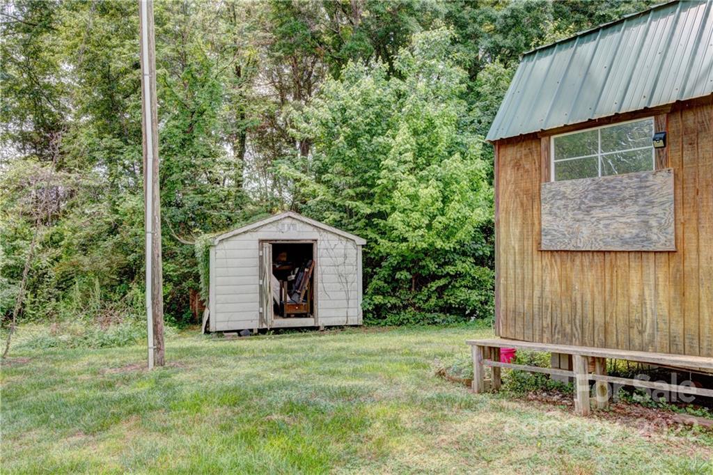 1119 Black Road Cherryville, NC 28021 - Photo 17 of 19 a backyard of a house with chairs and wooden fence