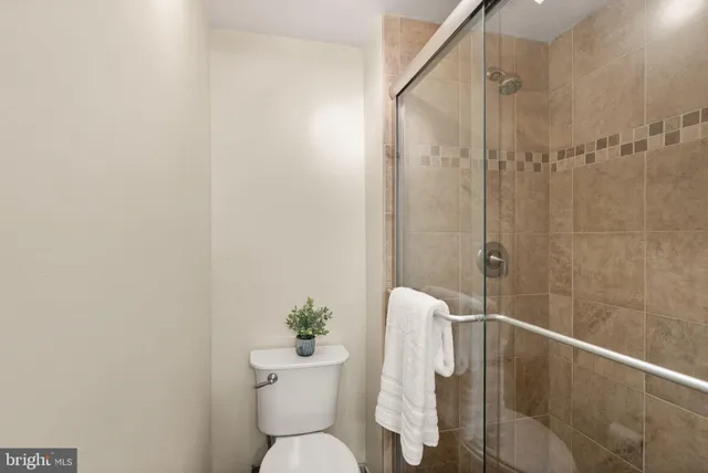 a bathroom with a toilet and a shower