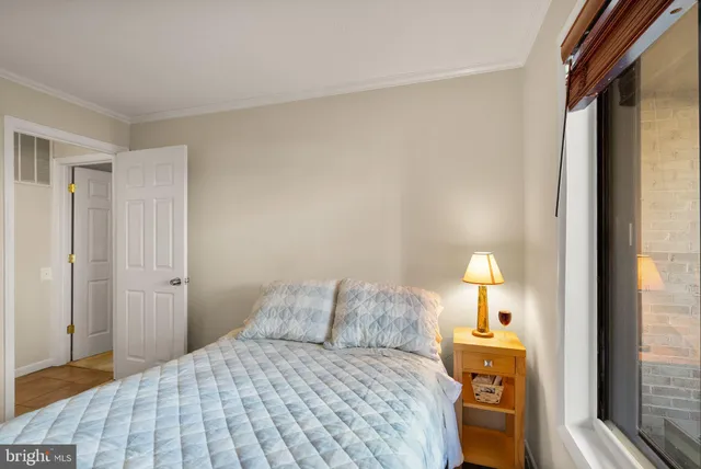 a bedroom with a bed and a lamp