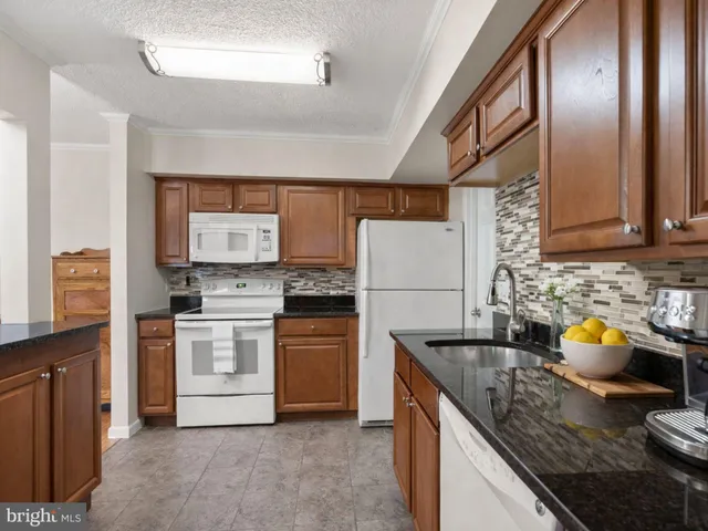 a kitchen that has a sink and a stove in it