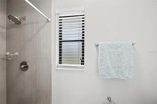 a bathroom with a shower curtain and a window
