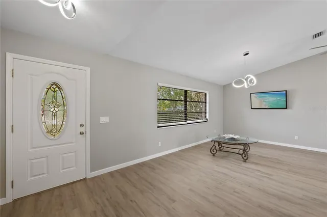 a view of room with workspace and wooden floor