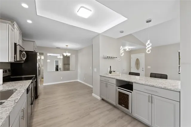 a large kitchen with cabinets and stainless steel appliances