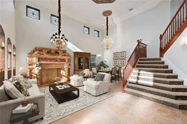a living room with furniture and a chandelier