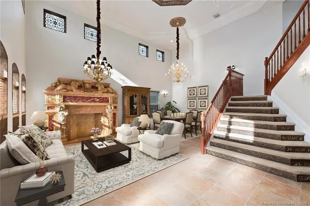 a living room with furniture and a chandelier