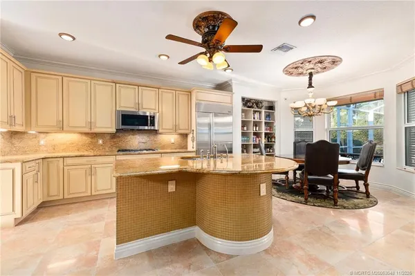 a kitchen with granite countertop a sink cabinets and window