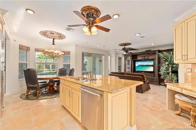 a very nice looking dining room with a large window and stainless steel appliances