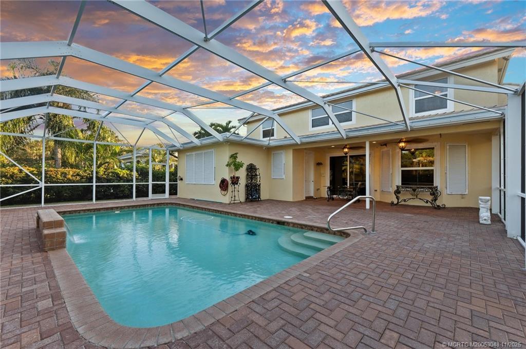 299 Southwest Lost River Road Stuart, FL 34997 - Photo 20 of 43 a view of a white building with swimming pool in front of it