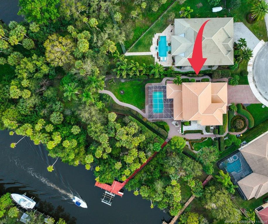 299 Southwest Lost River Road Stuart, FL 34997 - Photo 2 of 43 an aerial view of house with yard swimming pool and outdoor seating