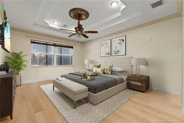 a spacious bedroom with a bed and ceiling fan