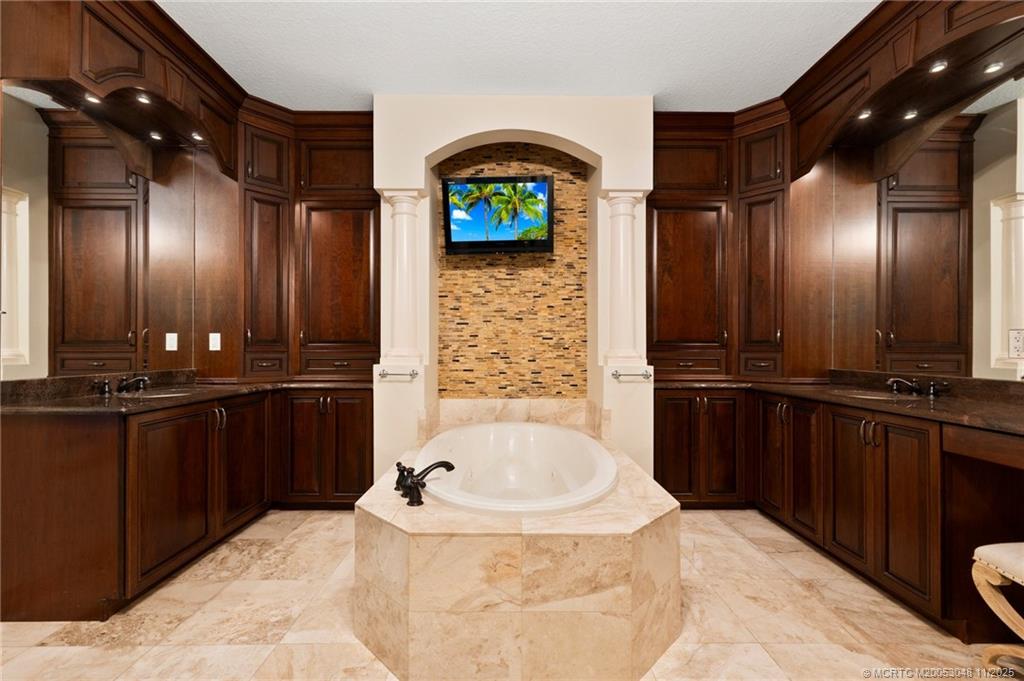 299 Southwest Lost River Road Stuart, FL 34997 - Photo 22 of 43 a bathroom with a sink and a large mirror