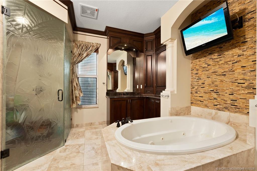 299 Southwest Lost River Road Stuart, FL 34997 - Photo 23 of 43 a bathroom with a bathtub and a shower