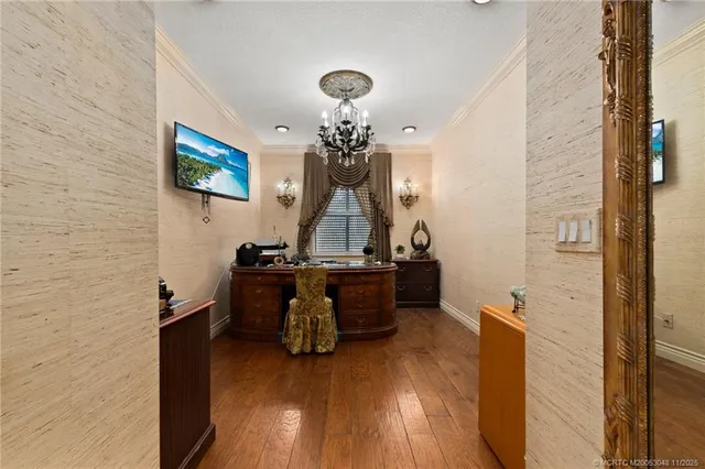 a view of a workspace with furniture and wooden floor