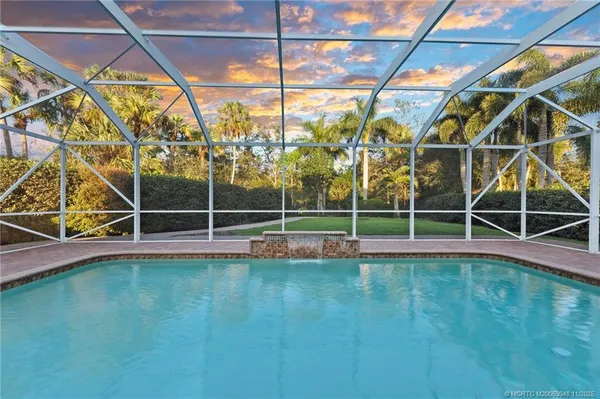 a view of a backyard with table and chairs