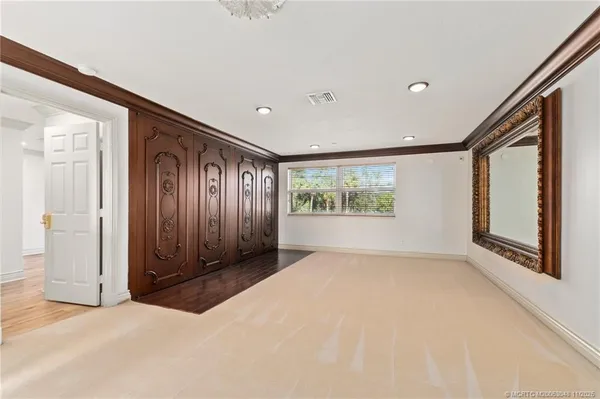 an empty room with windows and closet