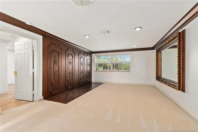 an empty room with windows and closet