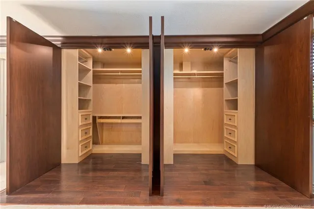 a view of walk in closet with wooden floor