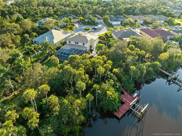 an aerial view of a houses with a yard