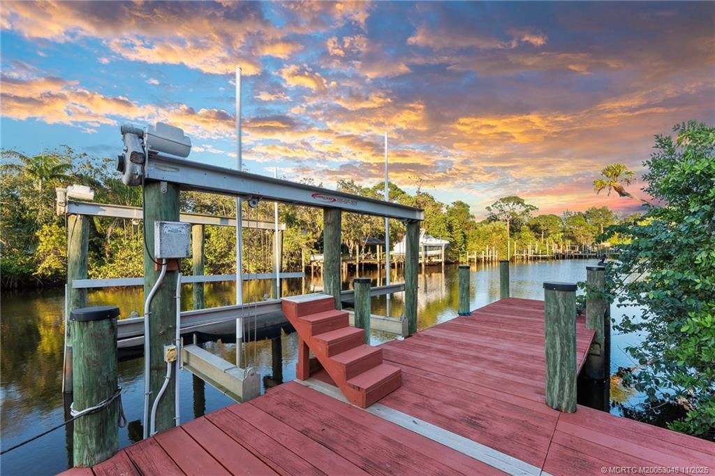 299 Southwest Lost River Road Stuart, FL 34997 - Photo 5 of 43 a view of a balcony with chairs and wooden floor